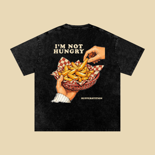 Back of the washed black I'm Not Hungry tee: a hand taking a fry from a red basket of fries, under the words I'M NOT HUNGRY.
